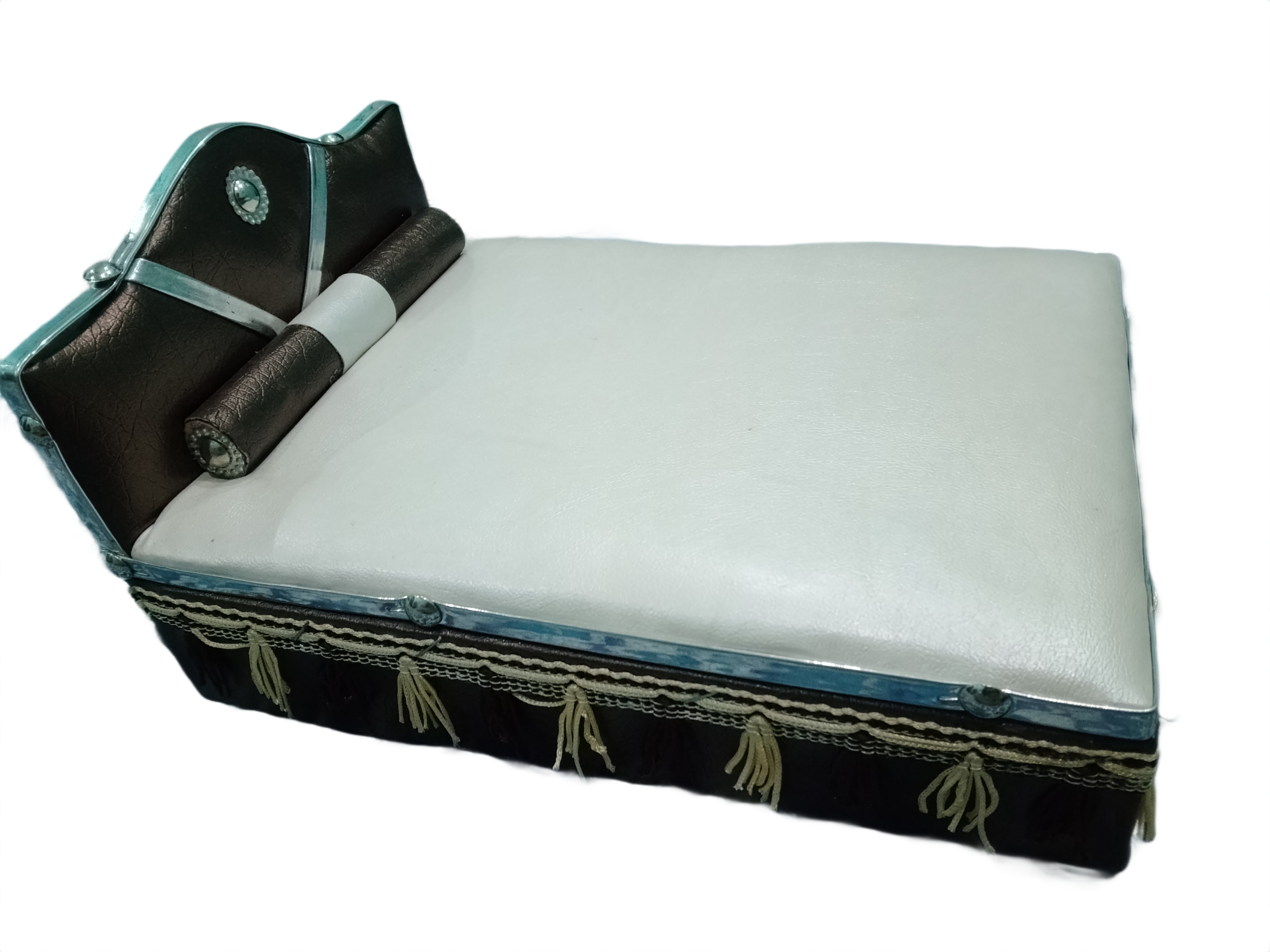 White cushion with black and turquoise trim on a white background