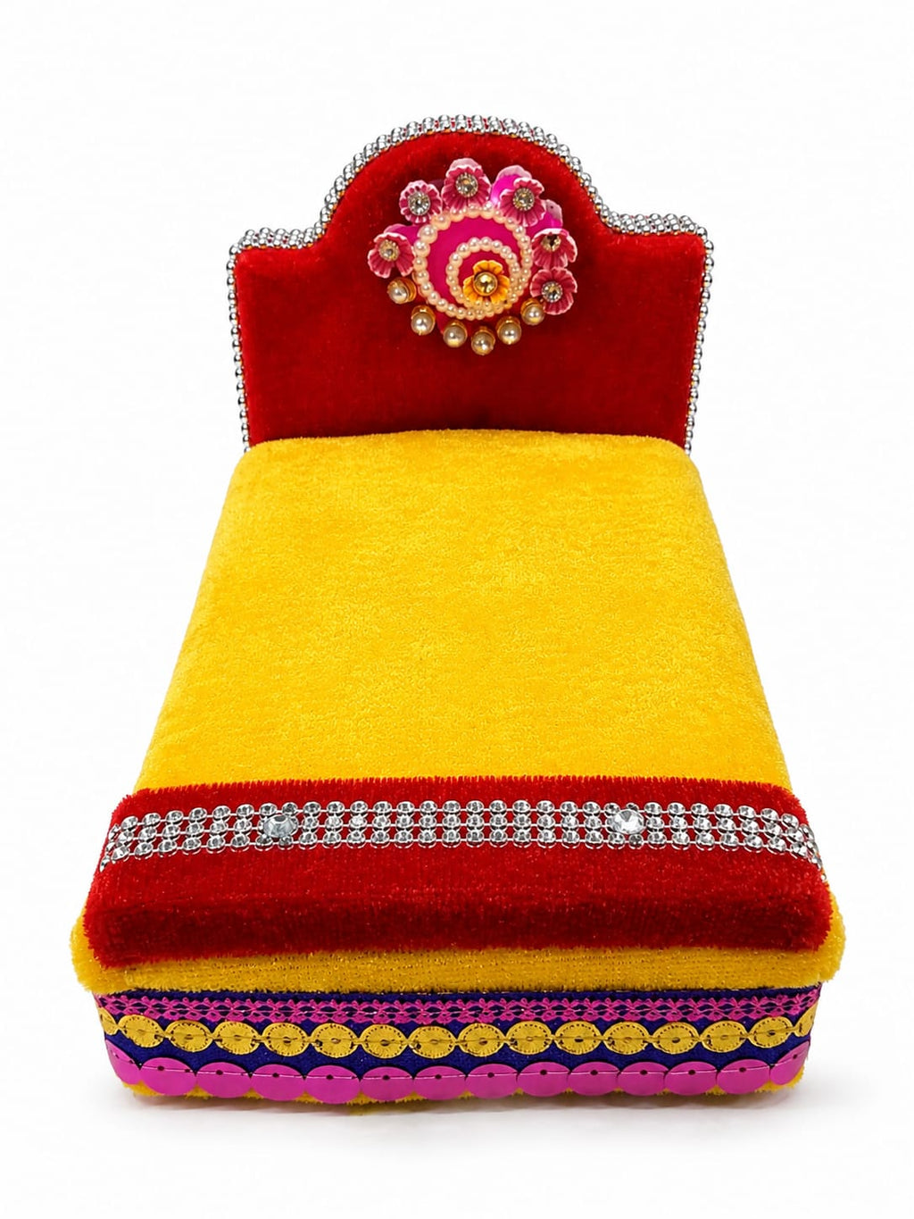 A vibrant, handcrafted decorative cushion or small bench featuring a bright yellow velvet body, a red velvet headrest, and intricate embellishments including silver rhinestone borders, a pink and gold floral motif on the headrest, and yellow sequins along the base.